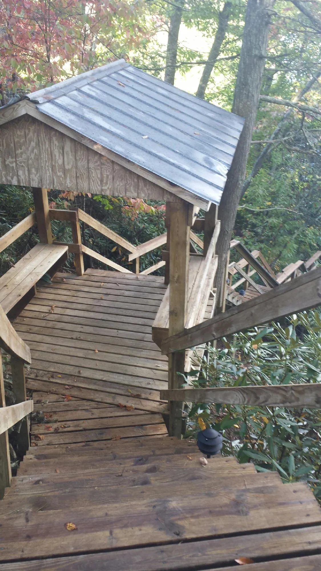 Metal roofed shelter over wooden steps on a wooded walkway — Skylight Repair & Installation work by our crew in West Newbury