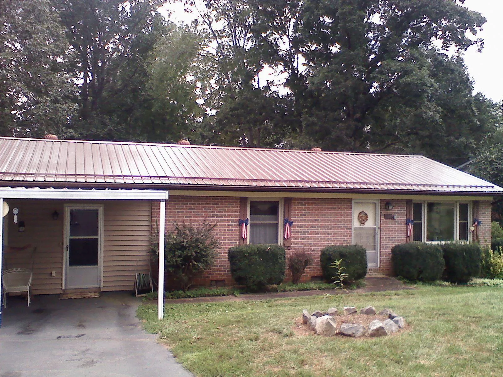 Bronze metal roof and carport on a brick ranch home — Roof Repair work by our crew in West Newbury